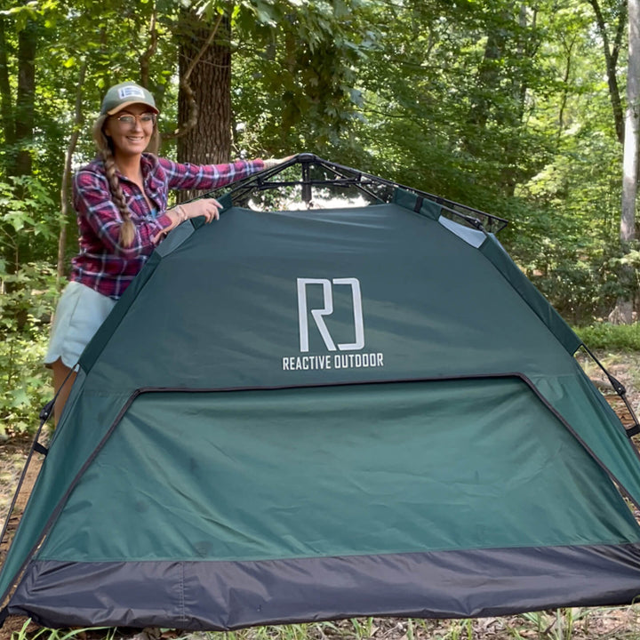 Portable 3 person tent folded down into its round carry bag