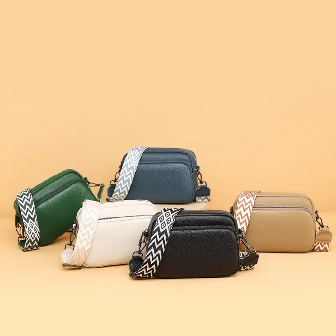 Minimalist leather handbag shown with everyday essentials