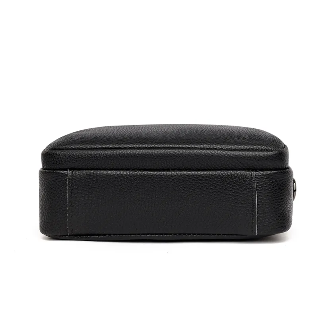 Womens leather handbag featuring multiple zippered compartments