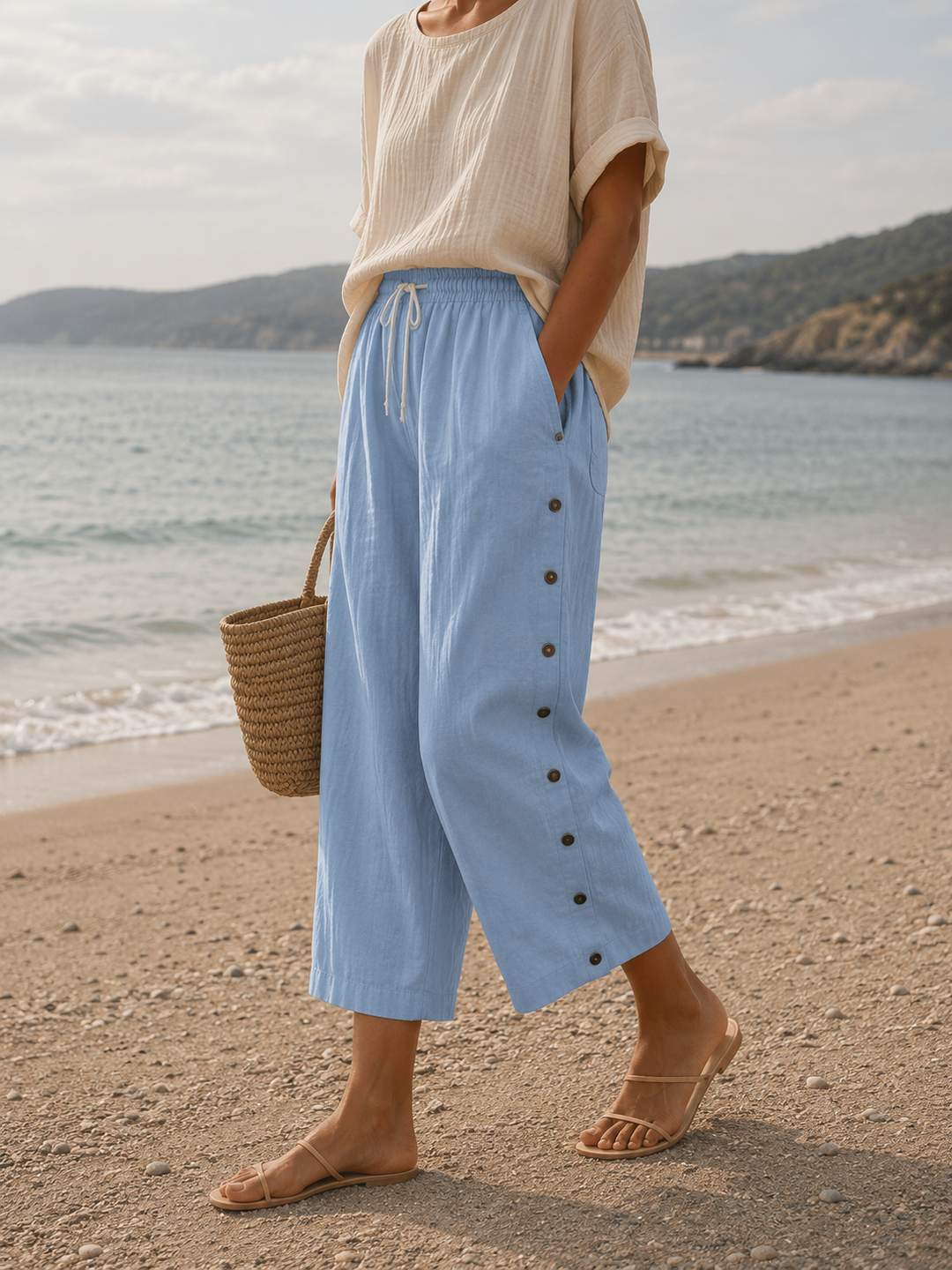 Women's casual capri pants featuring decorative button details on cropped hems
