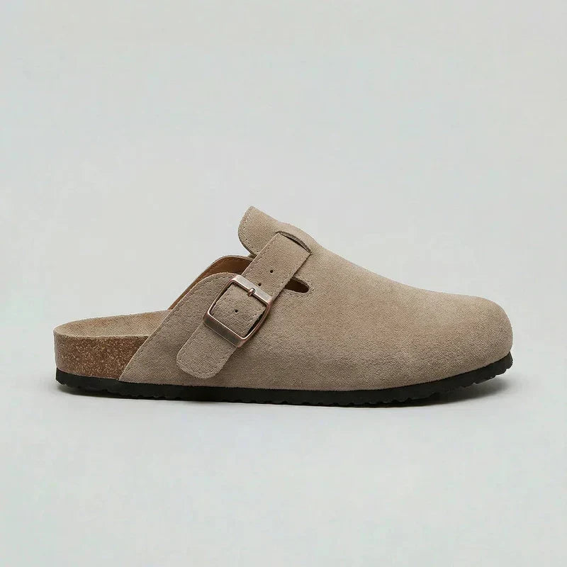 Side profile view of beige casual slip-on mule with adjustable buckle strap