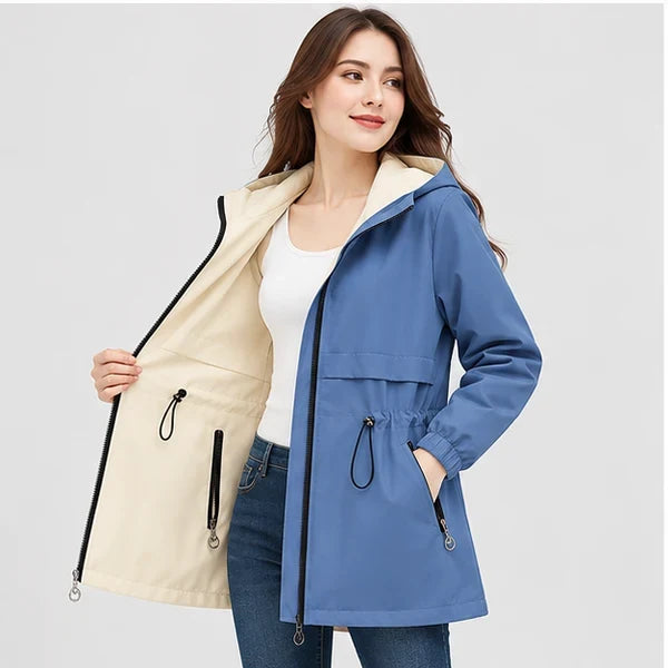 Woman wearing a blue and off-white reversible hooded parka