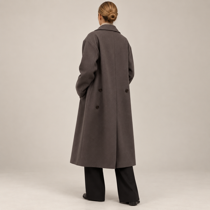 Back view of the elegant brown long coat showing the subtle movement slit