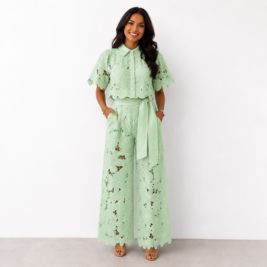 Woman wearing a green floral lace two-piece crop top and wide-leg trousers set