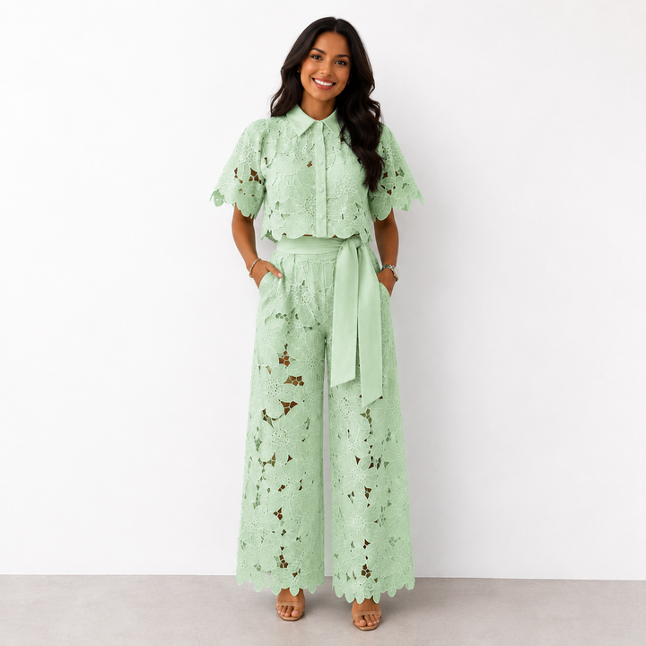 Woman wearing a green floral lace two-piece crop top and wide-leg trousers set