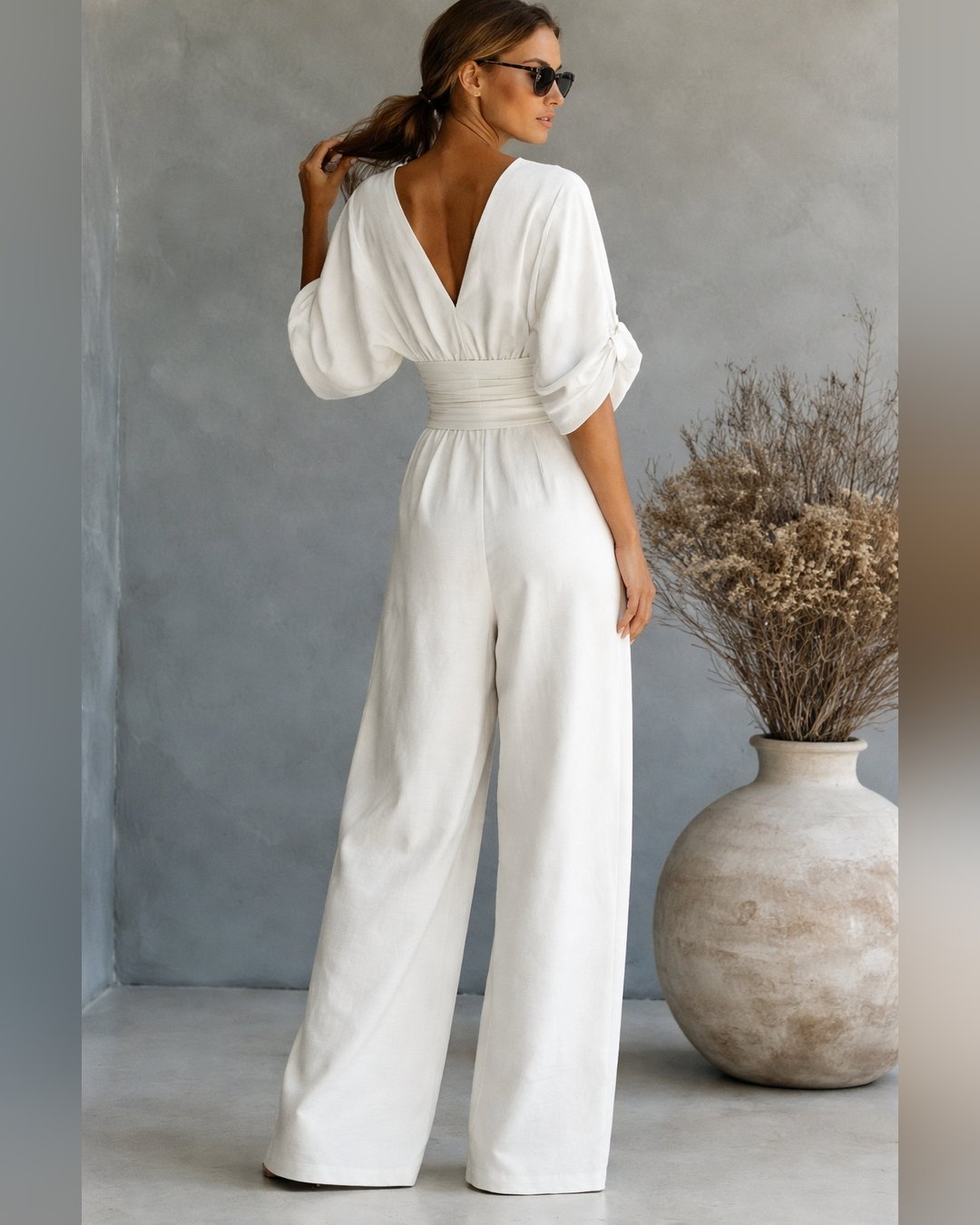 Full-length view of the trendy women's apparel collection V-neck jumpsuit