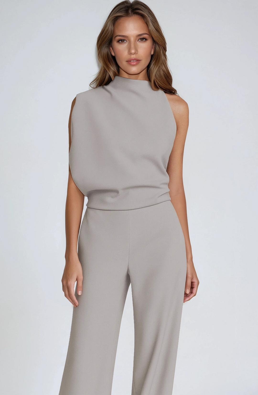 Model wearing a dark grey asymmetric one-shoulder jumpsuit