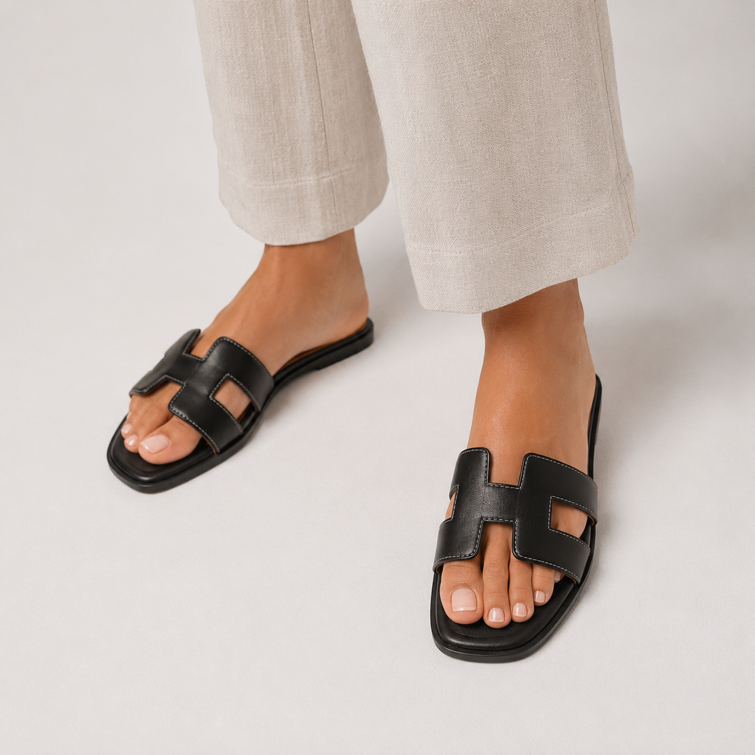 Women wearing black orthopedic flat slide sandals with open toe