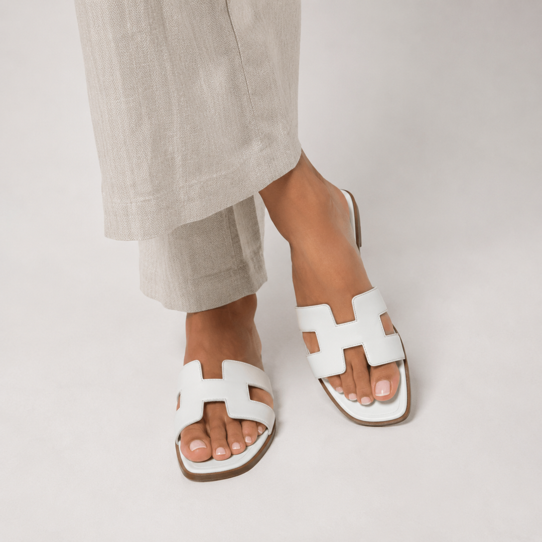 Women wearing white orthopedic flat slide sandals for summer