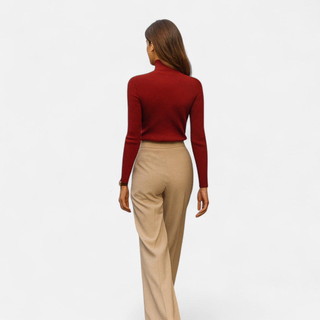 Back view of a woman wearing a red turtleneck sweater showcasing the slim fit silhouette