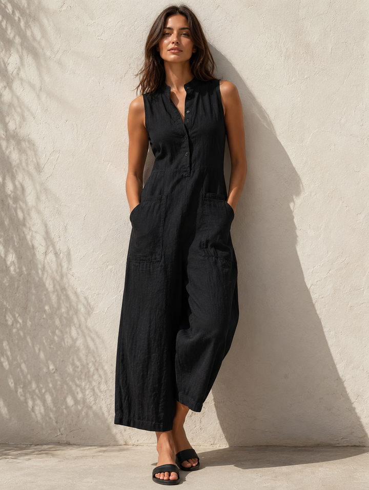 Woman wearing a black sleeveless wide leg jumpsuit with mandarin collar