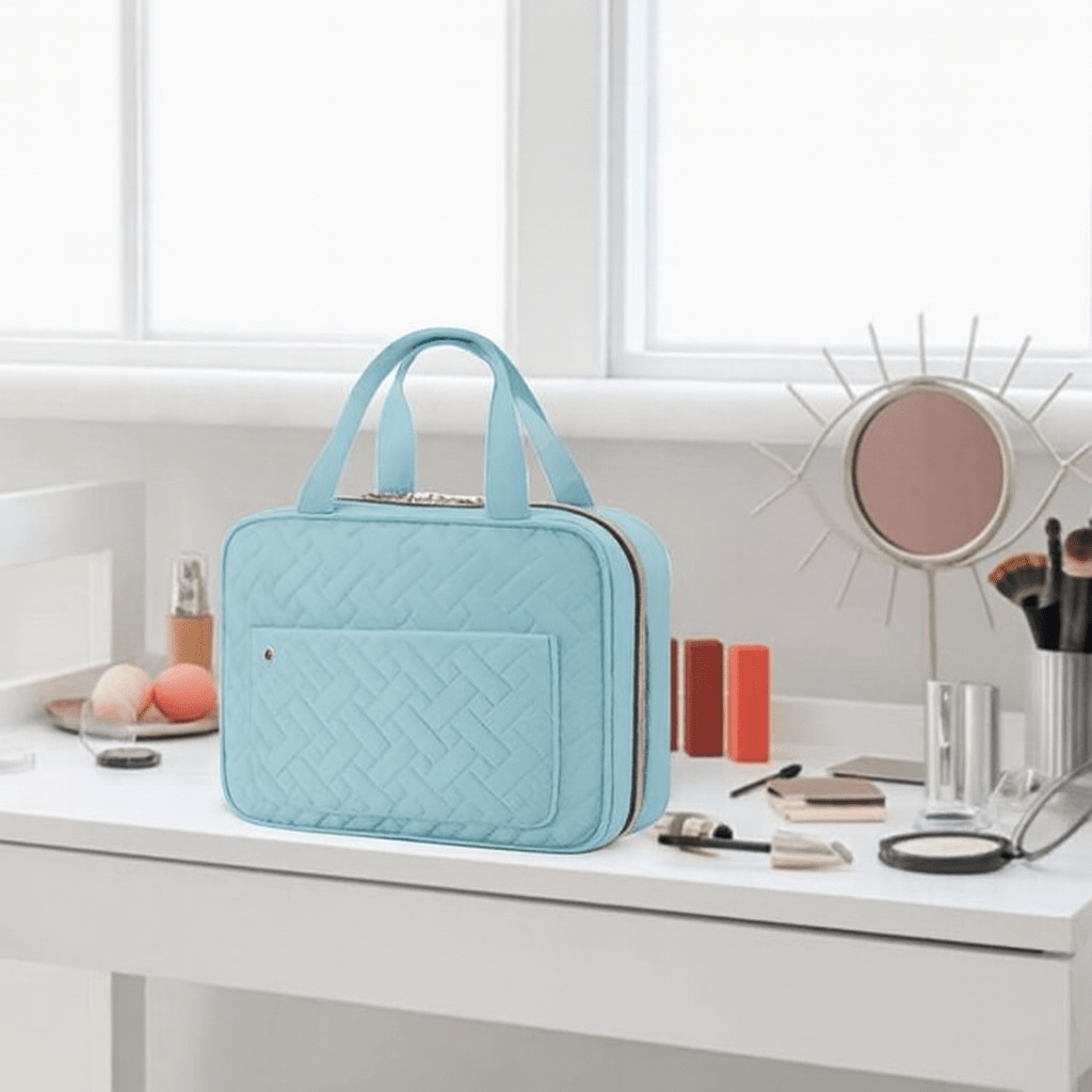 Pink travel cosmetics bag with 4 compartments open flat showing storage layout
