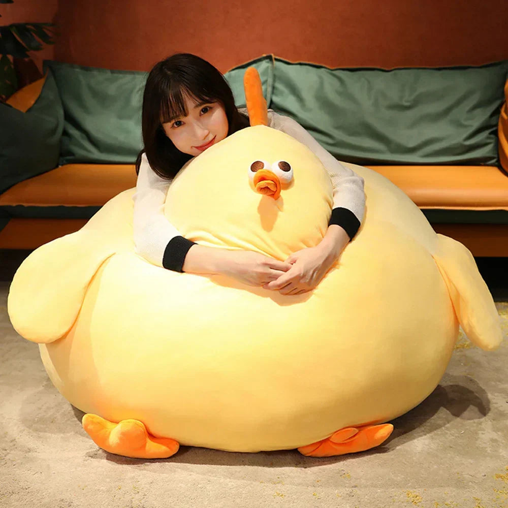 A woman cuddling the extra-large giant plush chicken on the floor