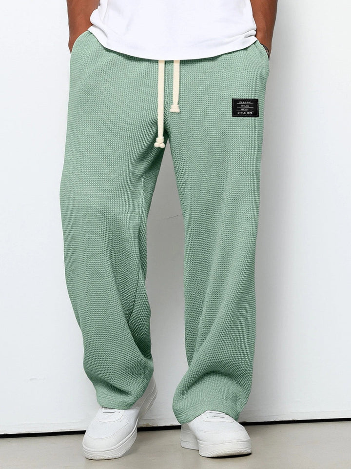 Close-up view of adjustable drawstring waist on mens relaxed fit trousers