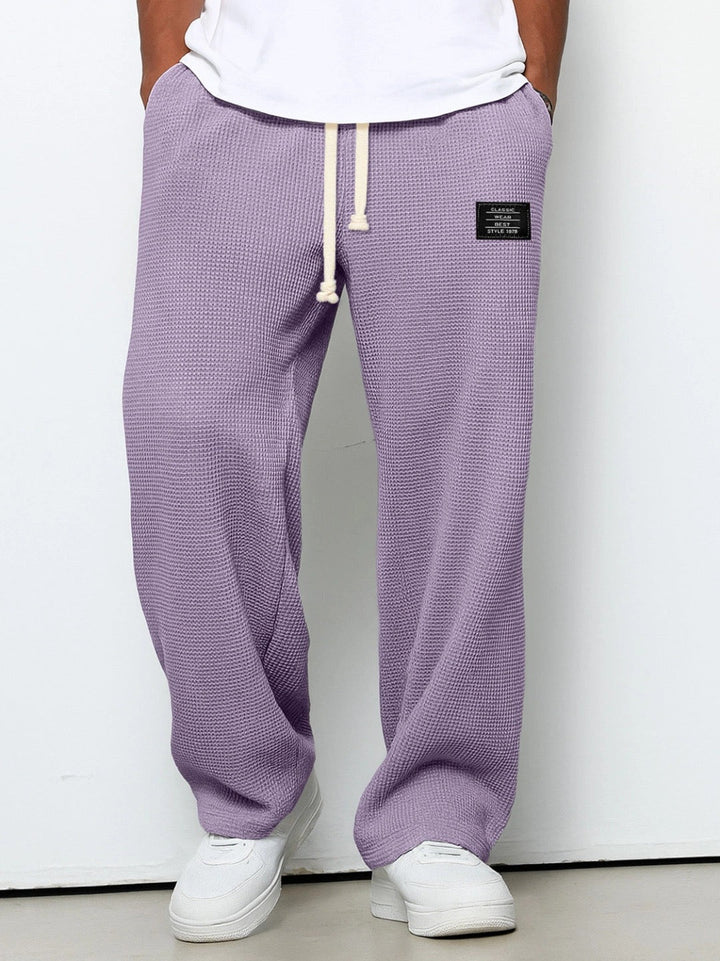 Detailed shot of fabric and stitching on mens streetwear drawstring trousers
