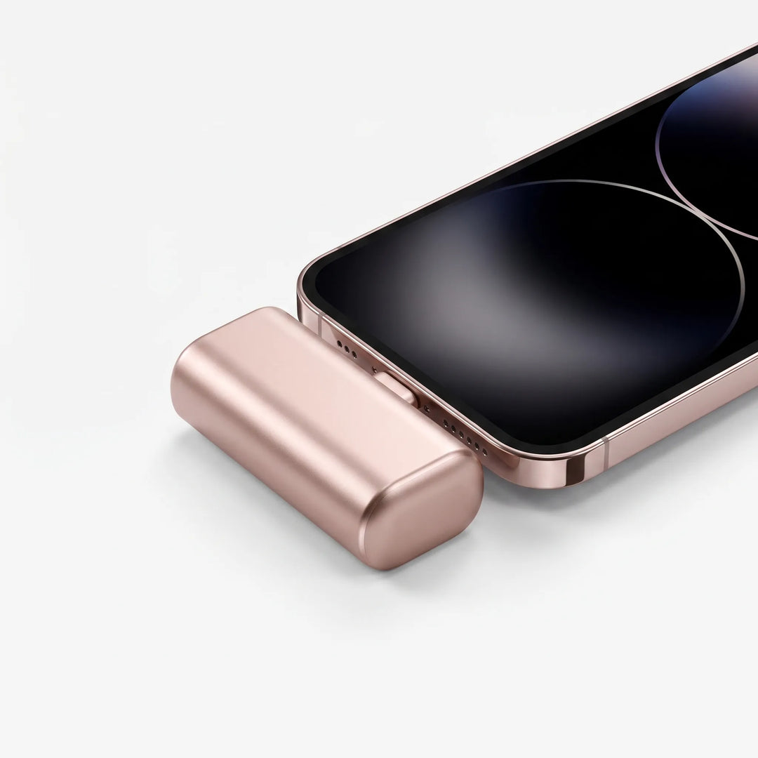 Compact capsule portable charger connected to a smartphone charging on the go