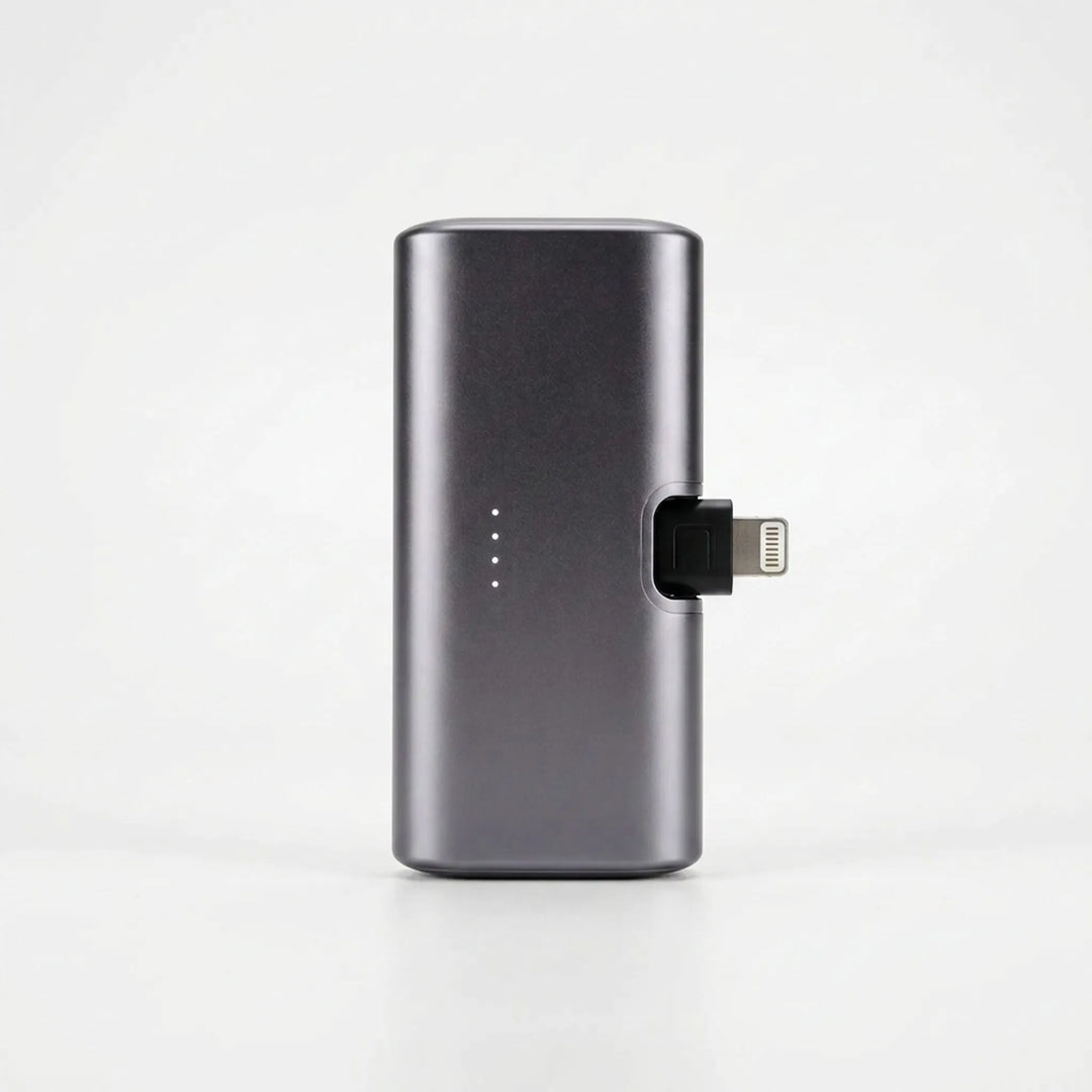 Portable charger with integrated plug showcased next to a modern smartphone
