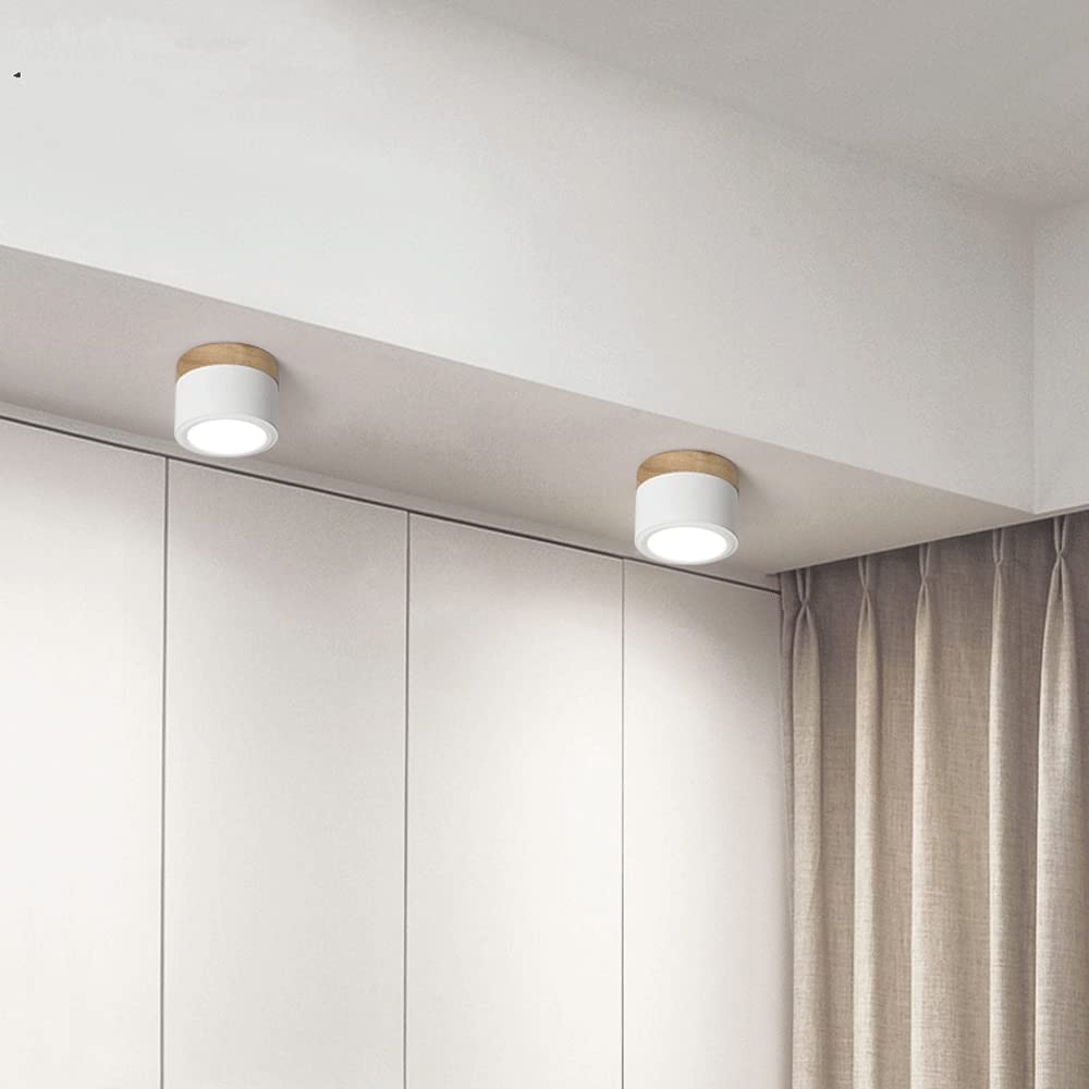 White cylindrical LED ceiling lights installed along a hallway ceiling