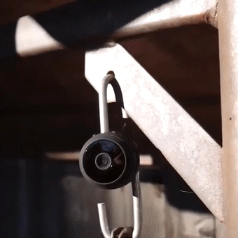 Wireless mini camera placed on a shelf for discreet home monitoring