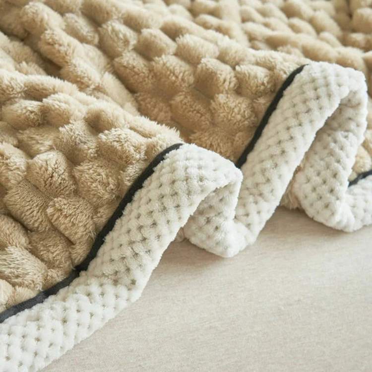 Close-up of the soft textured fabric and stitched edge of the weighted blanket