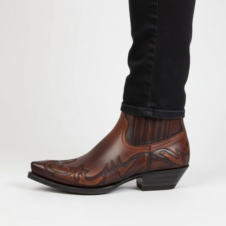 Brown leather western cowboy boots with traditional stitching and pointed toe