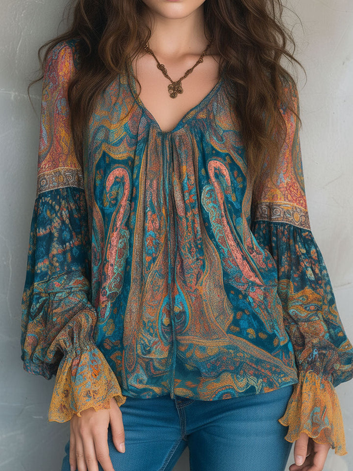 Close-up view of the Cyrano teal and amber paisley print blouse