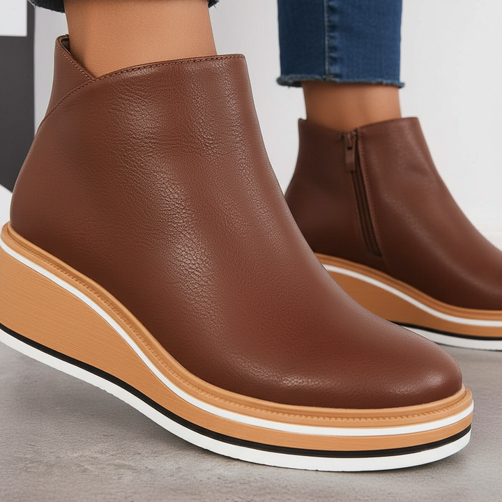 Detailed shot of brown wedge platform boot highlighting textured upper and layered sole