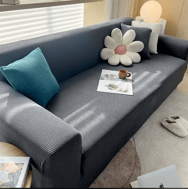 Dark grey sofa cover displayed on a modern couch in a living room