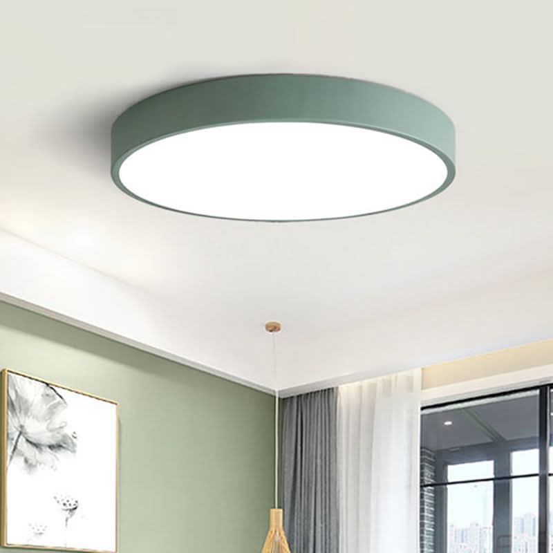 Green round LED ceiling light mounted on a white ceiling with green wall decor