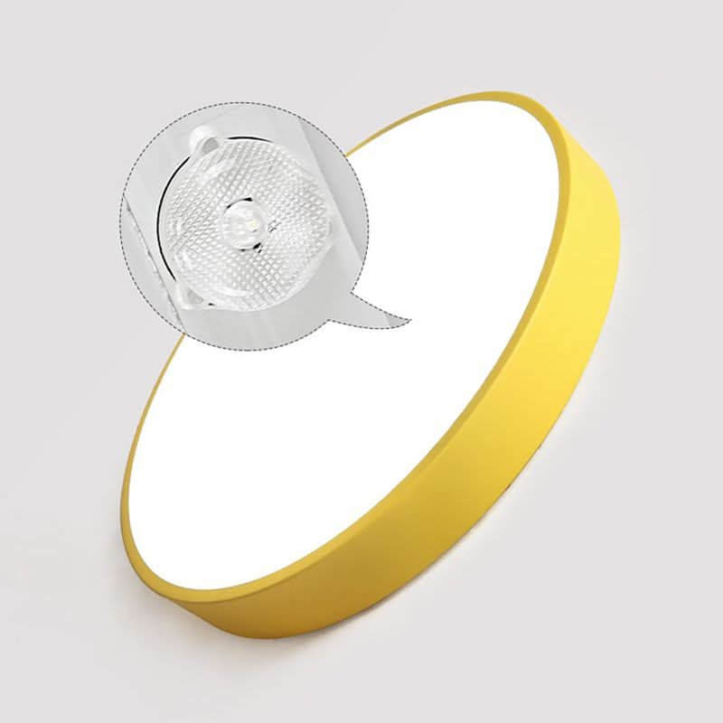 Minimalist round ceiling light turned on, casting a warm ambient glow in a home