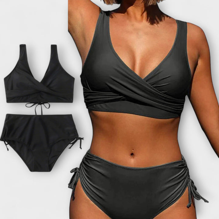 Woman wearing a black wrap-style two-piece bikini set with a flat lay view