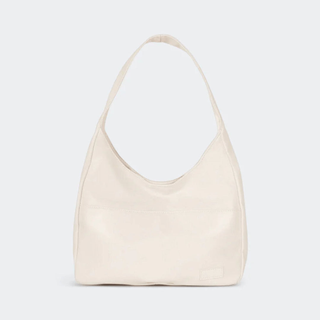 Women's vintage shoulder bag in black showing interior compartments for laptop and daily essentials