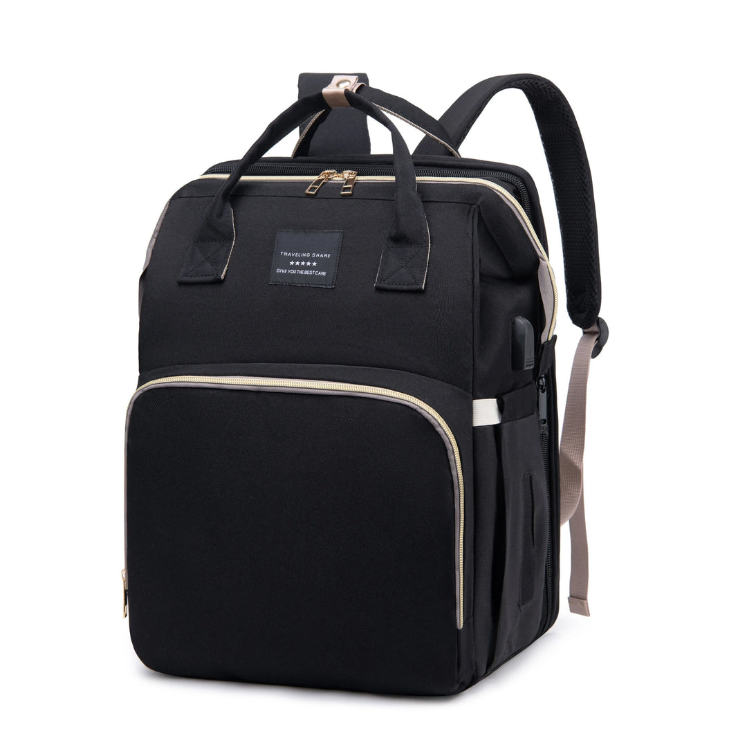 Baby travel backpack diaper bag viewed from the front showing main storage compartments