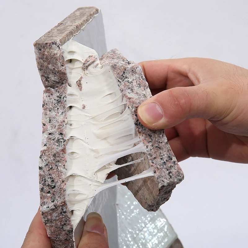 Close-up of heavy-duty adhesive tape stretching between two stone pieces