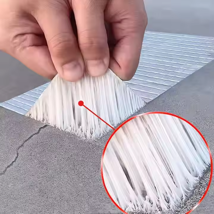 Demonstration of repair tape being applied over a crack in concrete