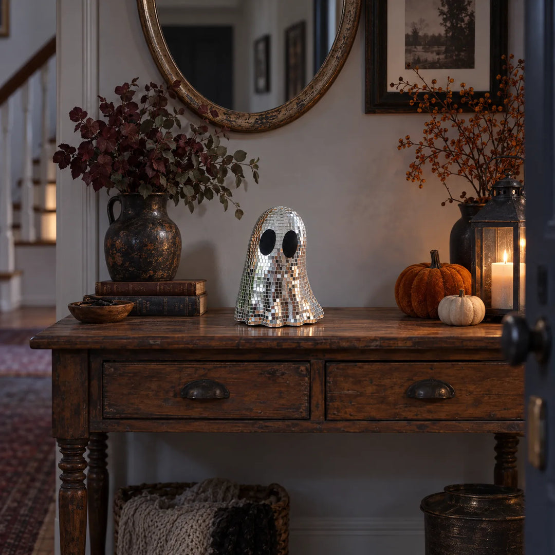 Disco ghost decoration displayed on a rustic entryway table during autumn