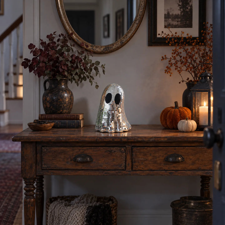 Disco ghost decoration displayed on a rustic entryway table during autumn