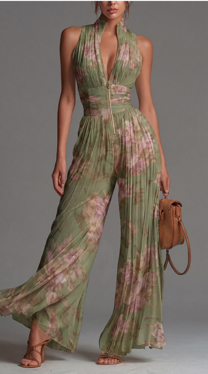 Model wearing green floral pleated wide-leg jumpsuit with deep V-neckline