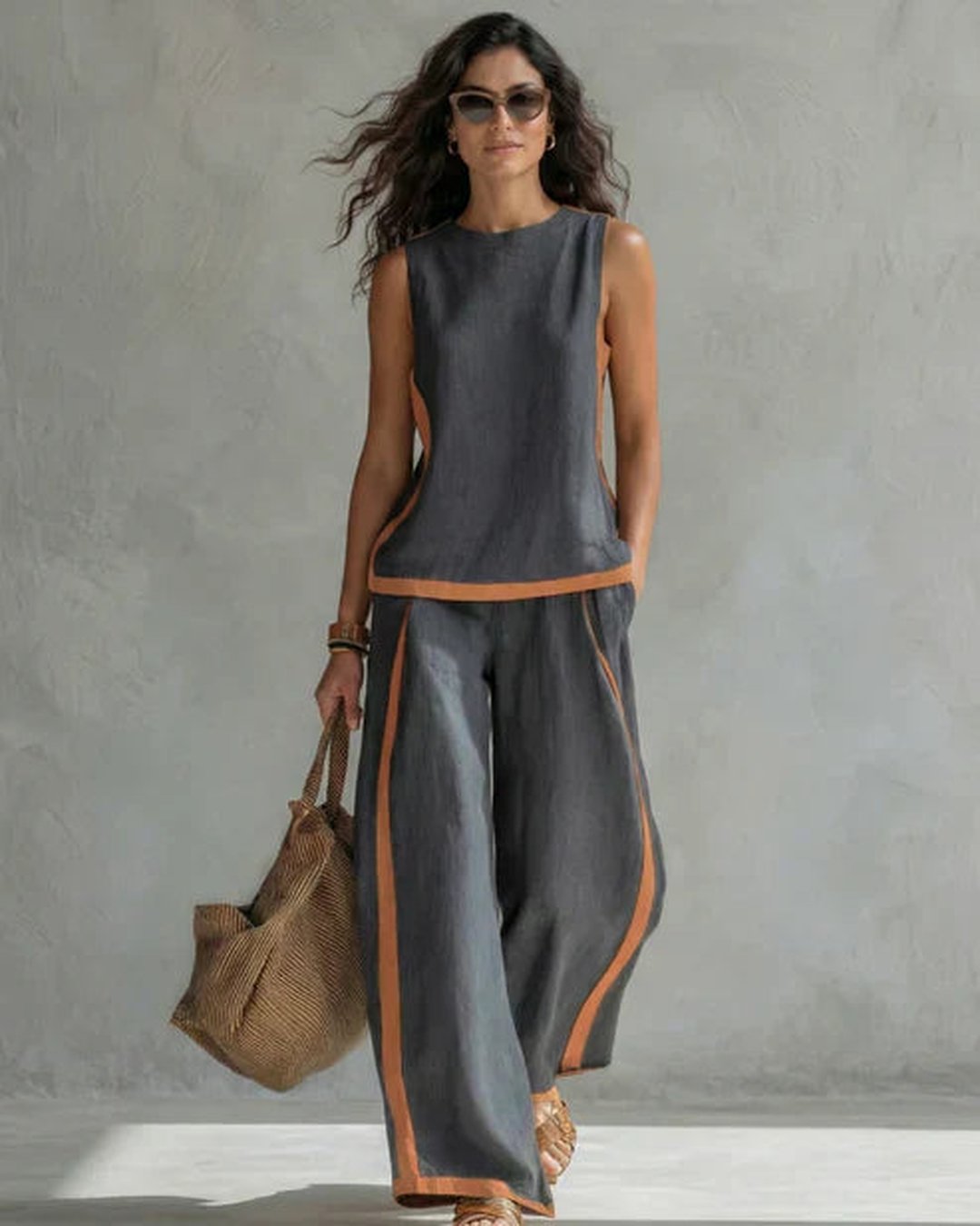 Woman wearing gray Kassia two-piece fluid set with handbag