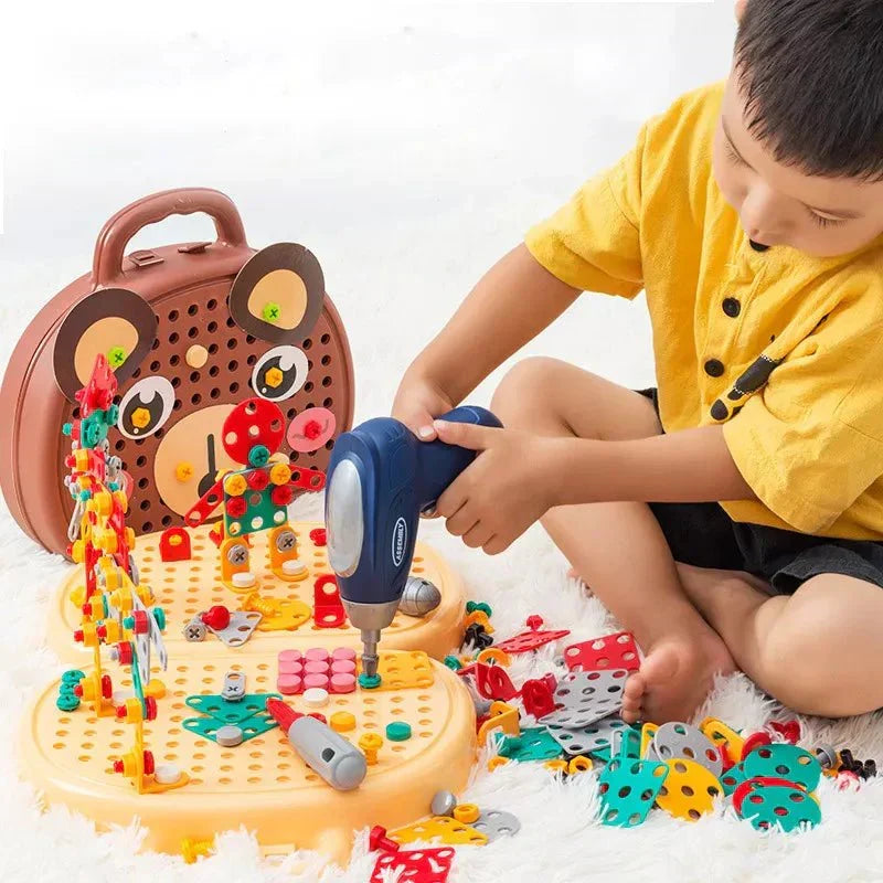 Young child playing with the construction toy set using a toy drill