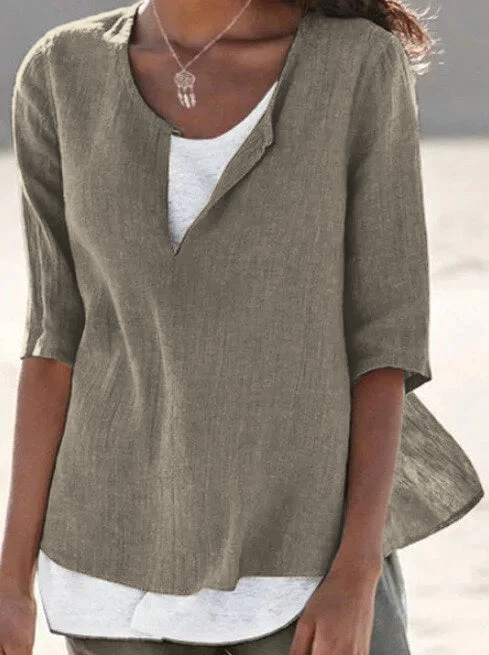 Woman wearing brown relaxed V-notch blouse with layered hem