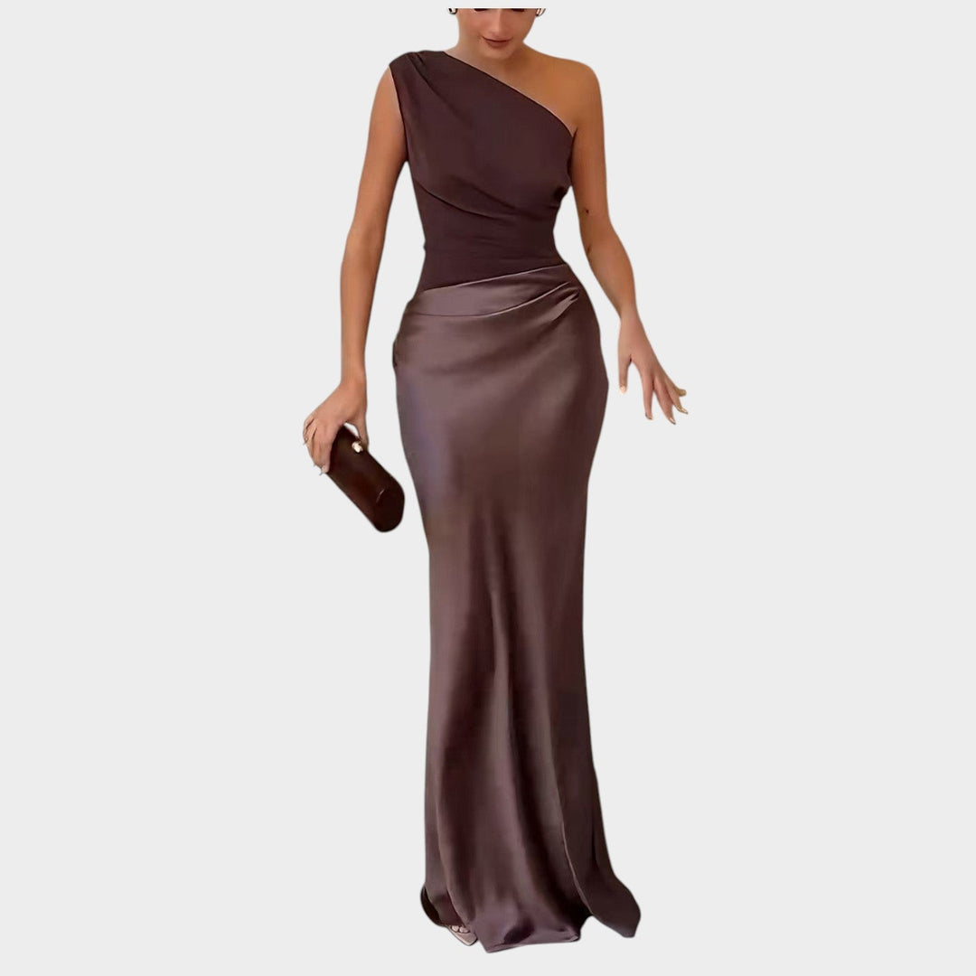 Full-length front view of a woman in a brown one-shoulder evening gown showcasing its fitted bodice and fluid skirt