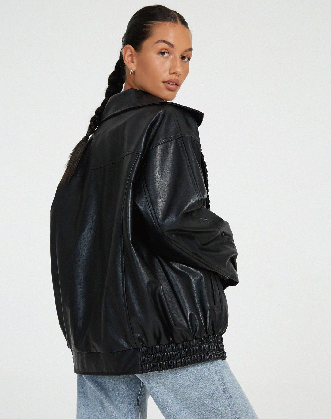 Back view of brown oversized biker jacket showing relaxed fit streetwear