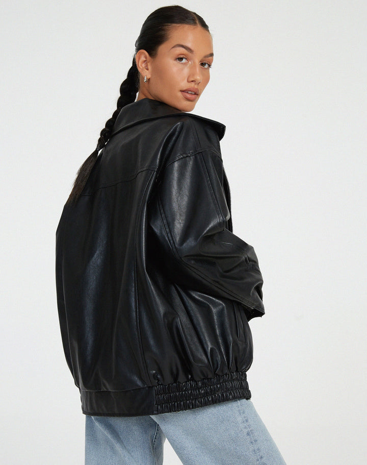 Back view of brown oversized biker jacket showing relaxed fit streetwear