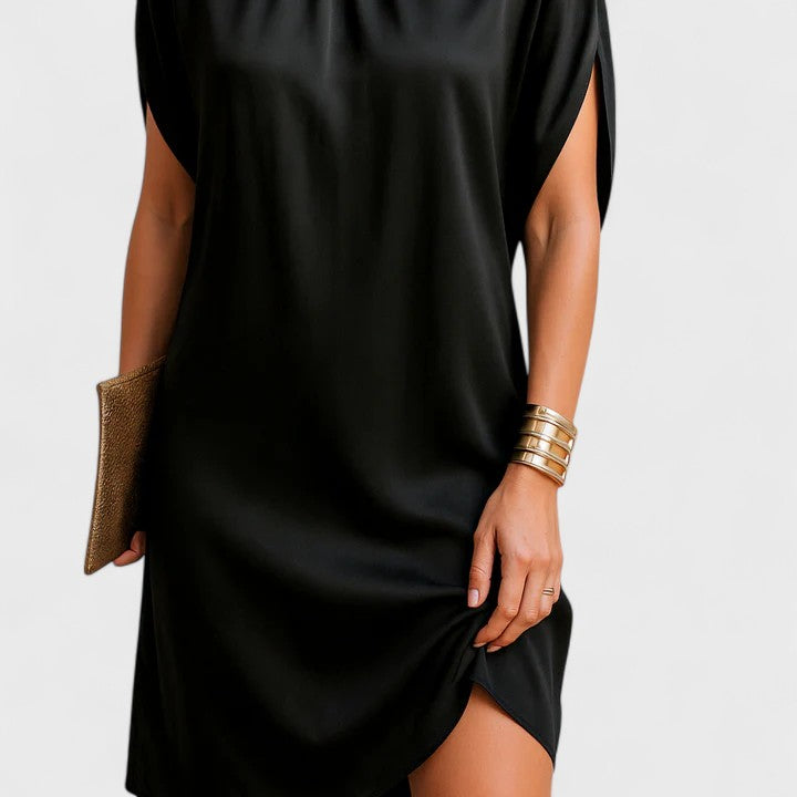 Detail of the side slit hem on a stylish black women's dress