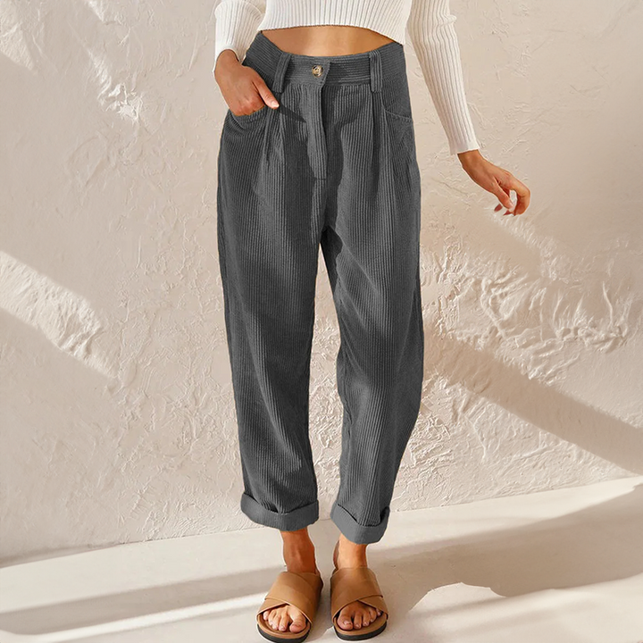 Close-up view of soft textured corduroy fabric on women's casual tapered trousers