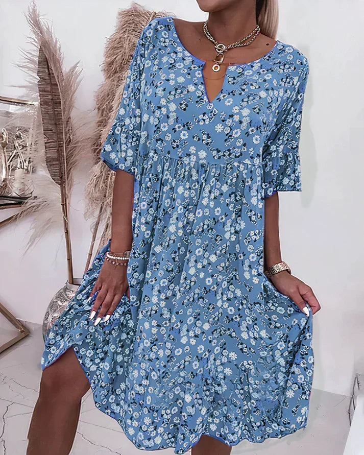 Model wearing blue floral shift dress with half sleeves