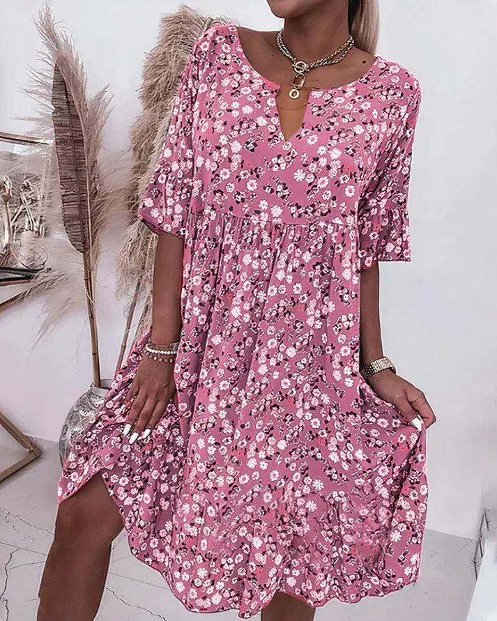 Model wearing pink floral shift dress with V-neck