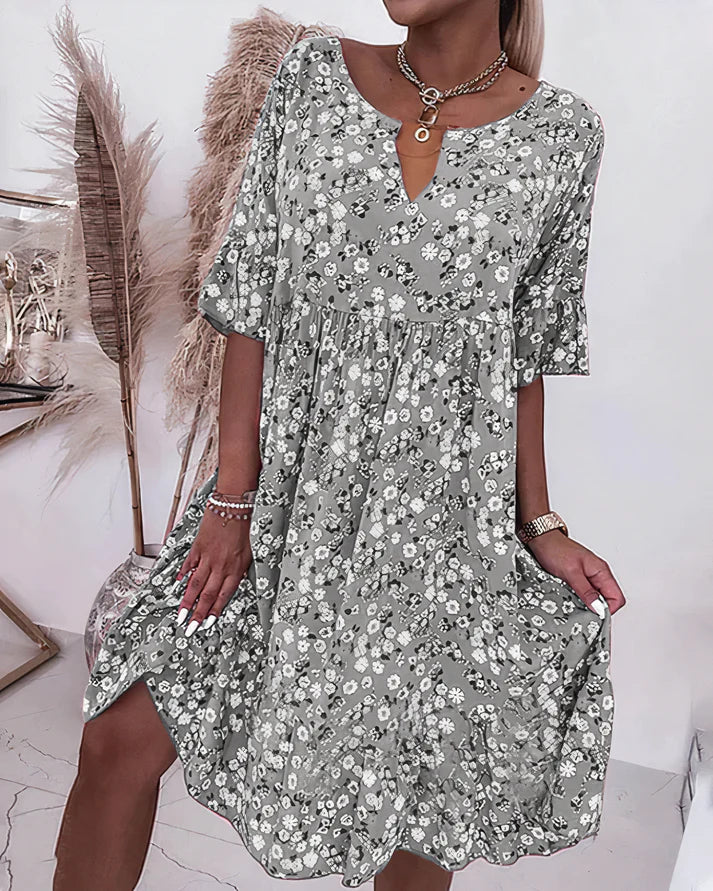 Model wearing grey floral shift dress with relaxed fit