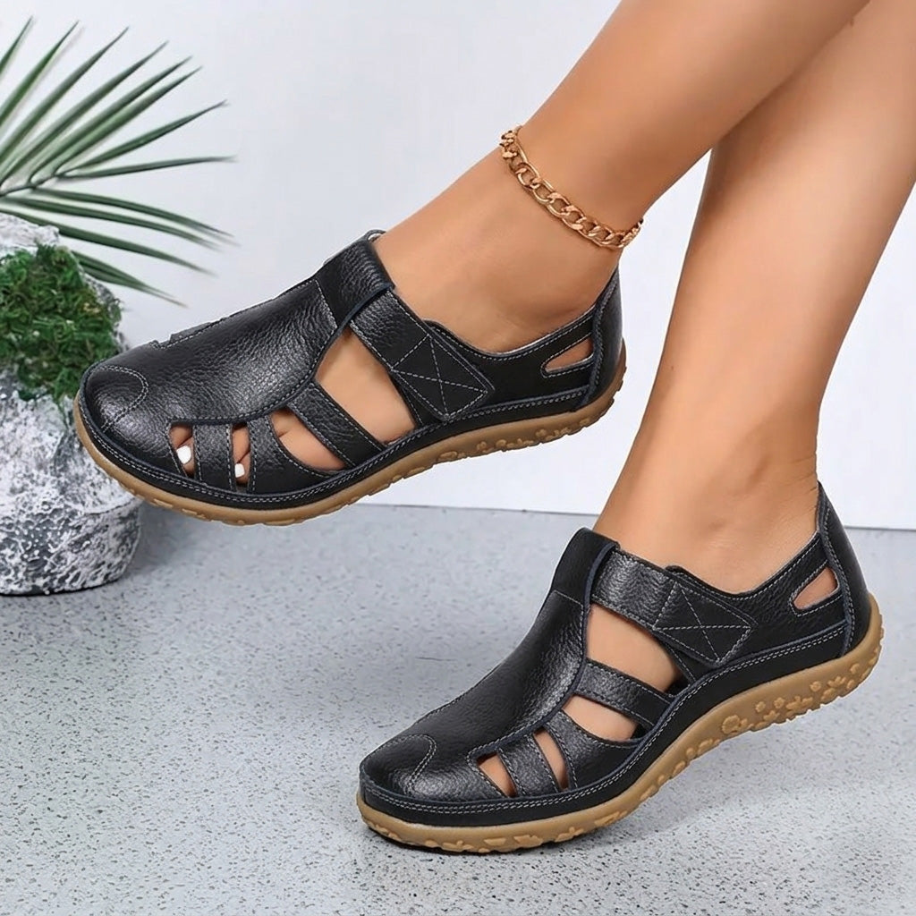 A woman wearing black arch support walking sandals outdoors
